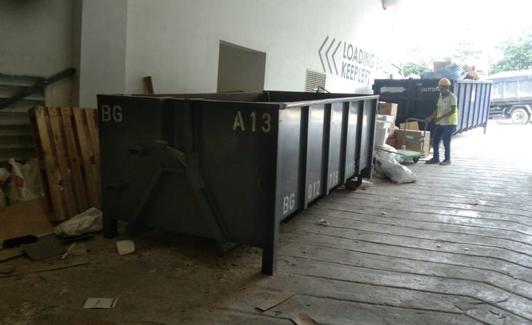 a man standing in front of a large metal container